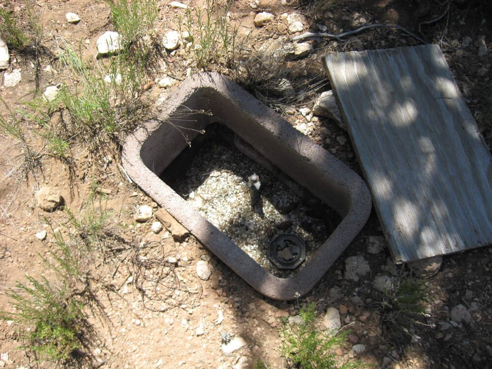 A water meter box set into the ground